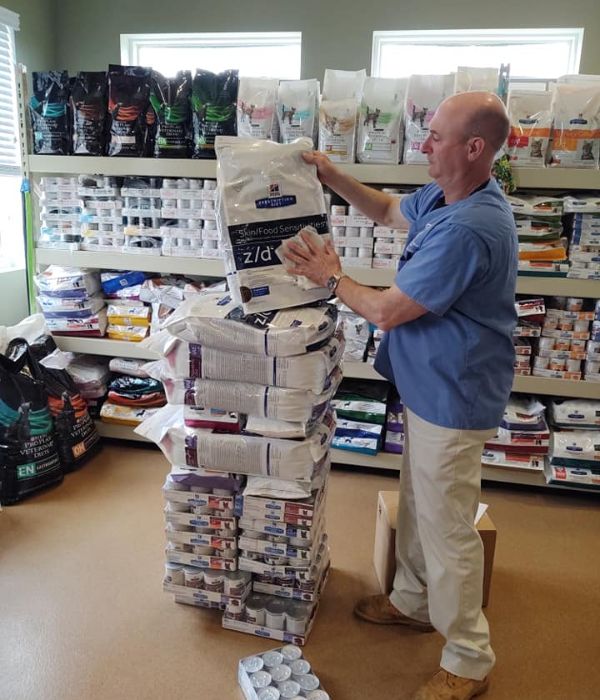 A man wiping pet diet packets with a towel